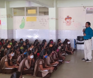 a person standing in front of a group of people wearing masks