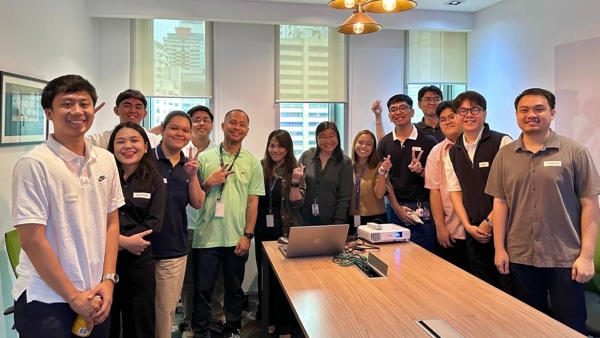 a group of people standing around a table