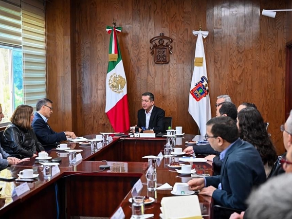 a group of people sitting around a table
