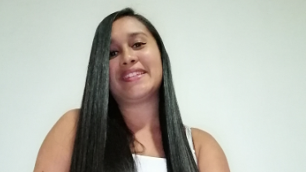 a person with long hair smiling