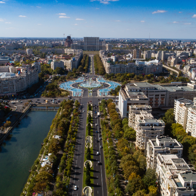 a city with a fountain and buildings