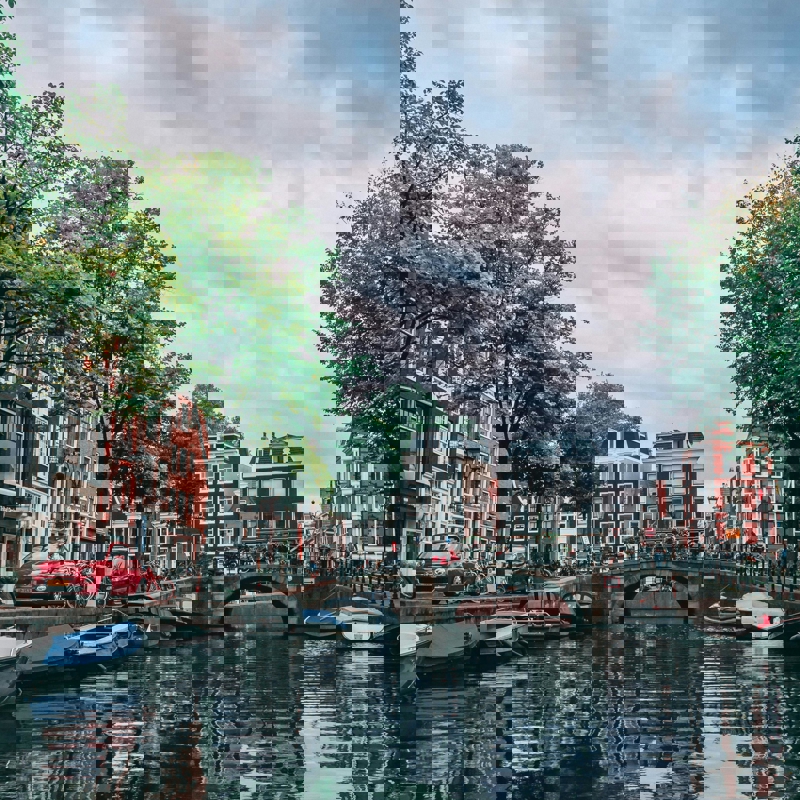 a river with boats and buildings on the side