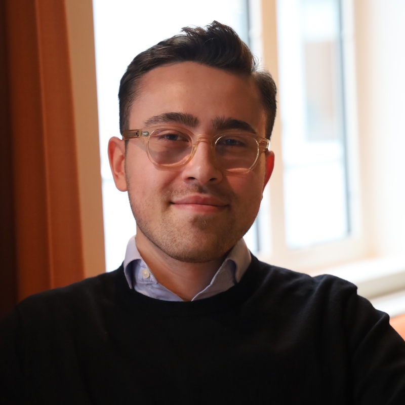 a person wearing glasses and a black shirt