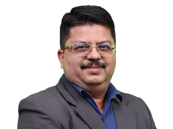 a person wearing glasses and a suit
