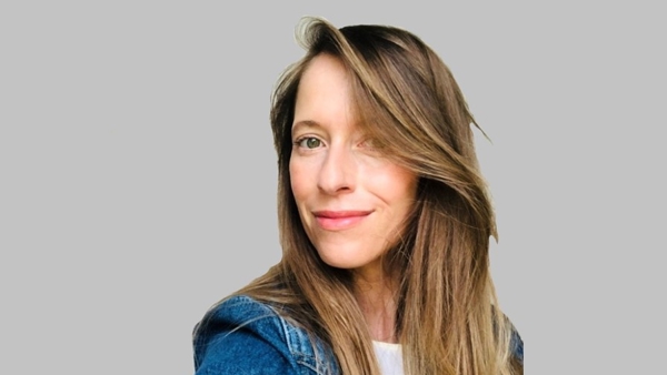 a person with long hair smiling