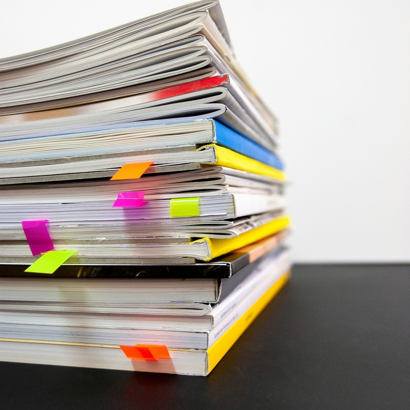 a stack of books with colorful paper clips