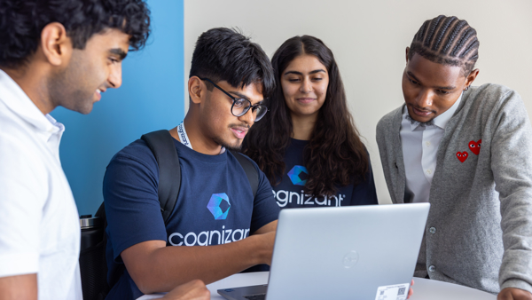 a group of people looking at a laptop