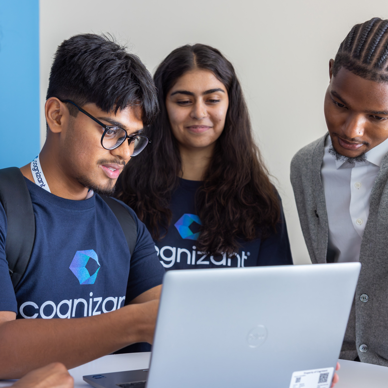 a group of people looking at a laptop