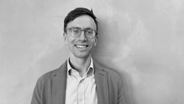 a person wearing glasses and a jacket