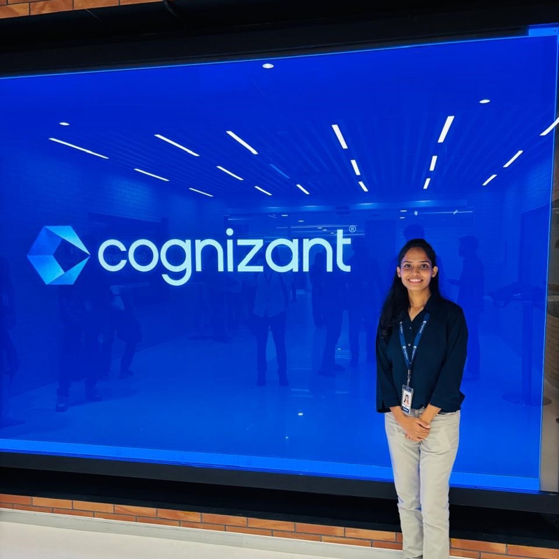 a person standing in front of a large blue sign