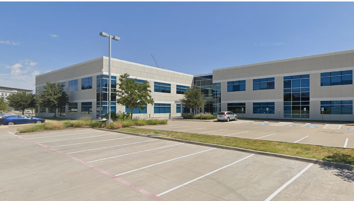 a building with a lot of parking lot