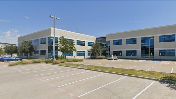 a building with a lot of parking lot