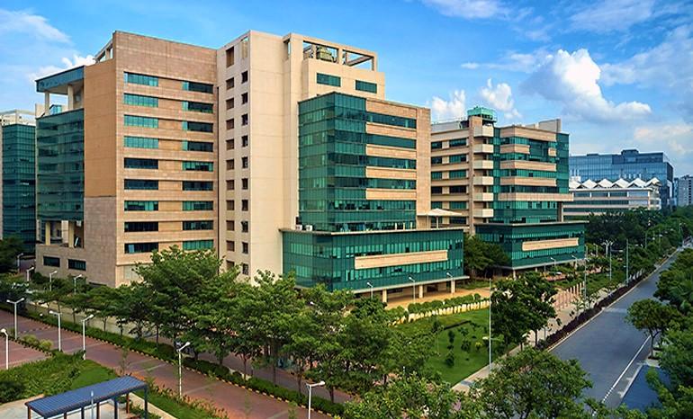 a group of buildings with trees and a road