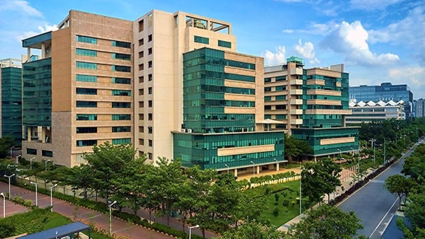 a group of buildings with trees and a road