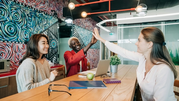 a group of people giving each other a high five