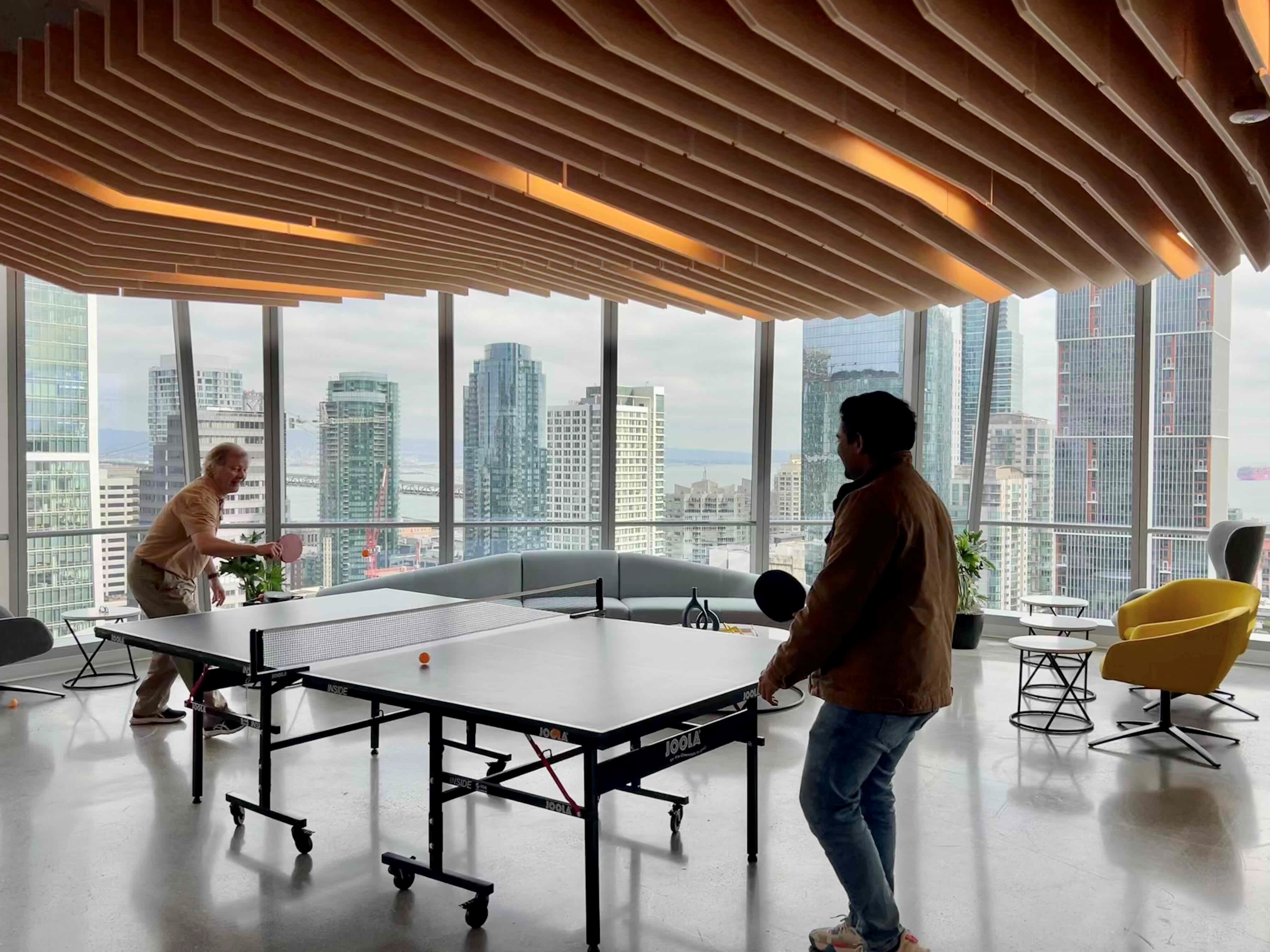 a group of men playing ping pong