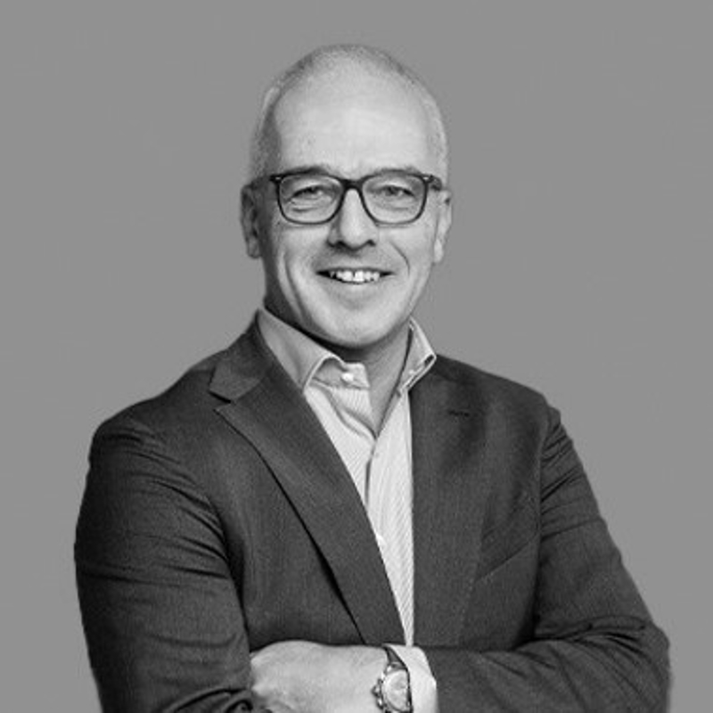 a person wearing glasses and a suit