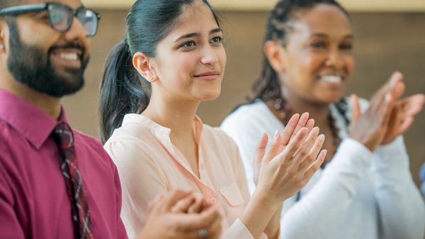 a group of people clapping