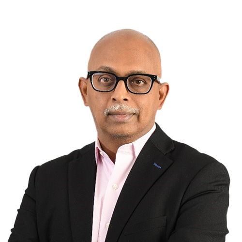 a person wearing glasses and a suit