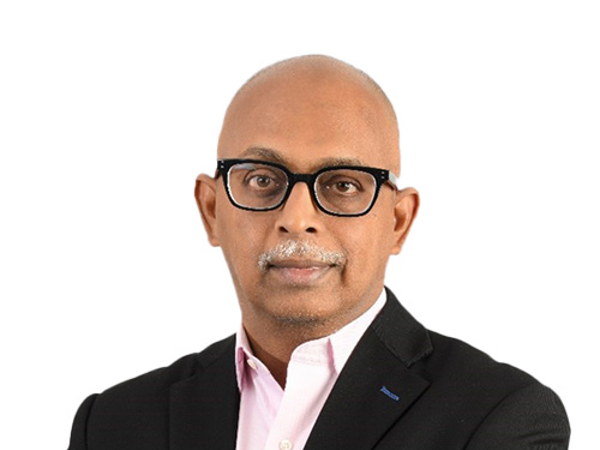 a person wearing glasses and a suit