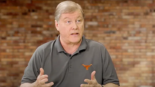 a person in a grey polo shirt