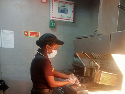 a person wearing a mask and gloves at a restaurant