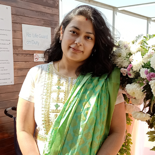 a person standing in front of flowers