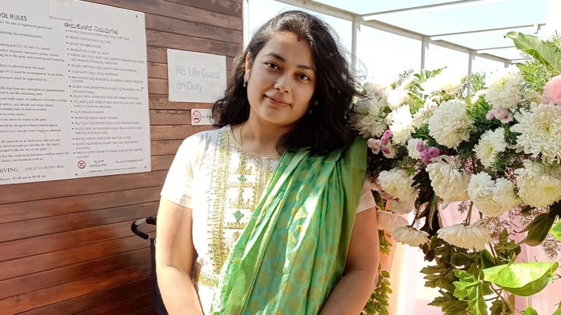 a person standing in front of flowers