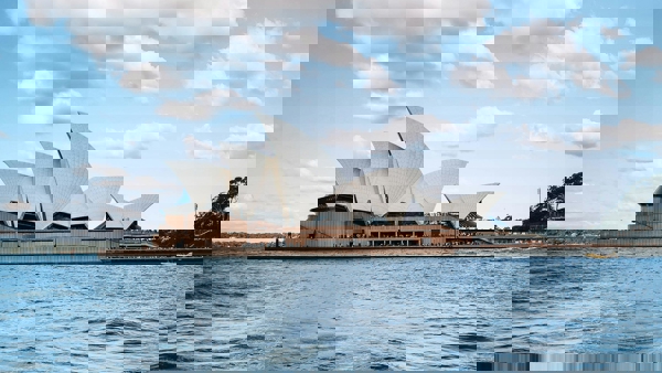 a building with pointed roofs on a body of water