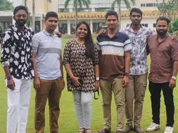 a group of people standing on grass