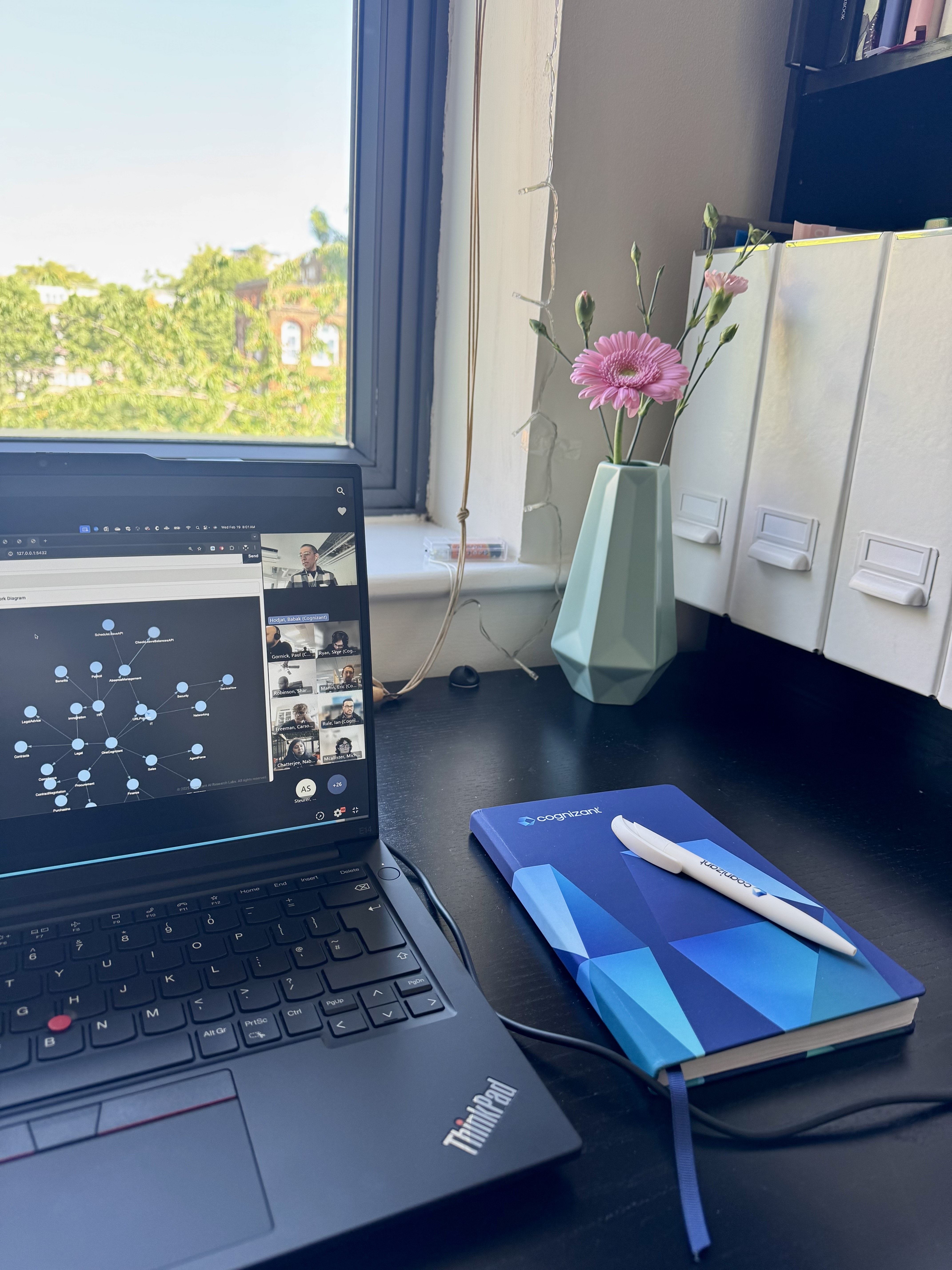 a laptop and a notebook on a desk