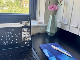 a laptop and a notebook on a desk