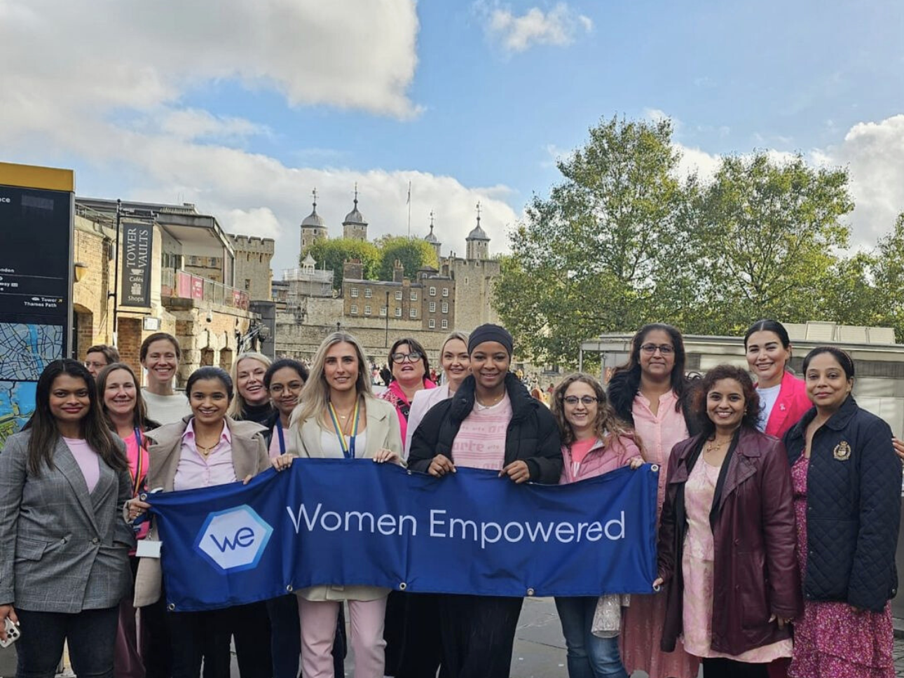 a group of women holding a banner