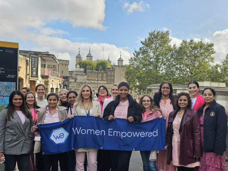 a group of women holding a banner