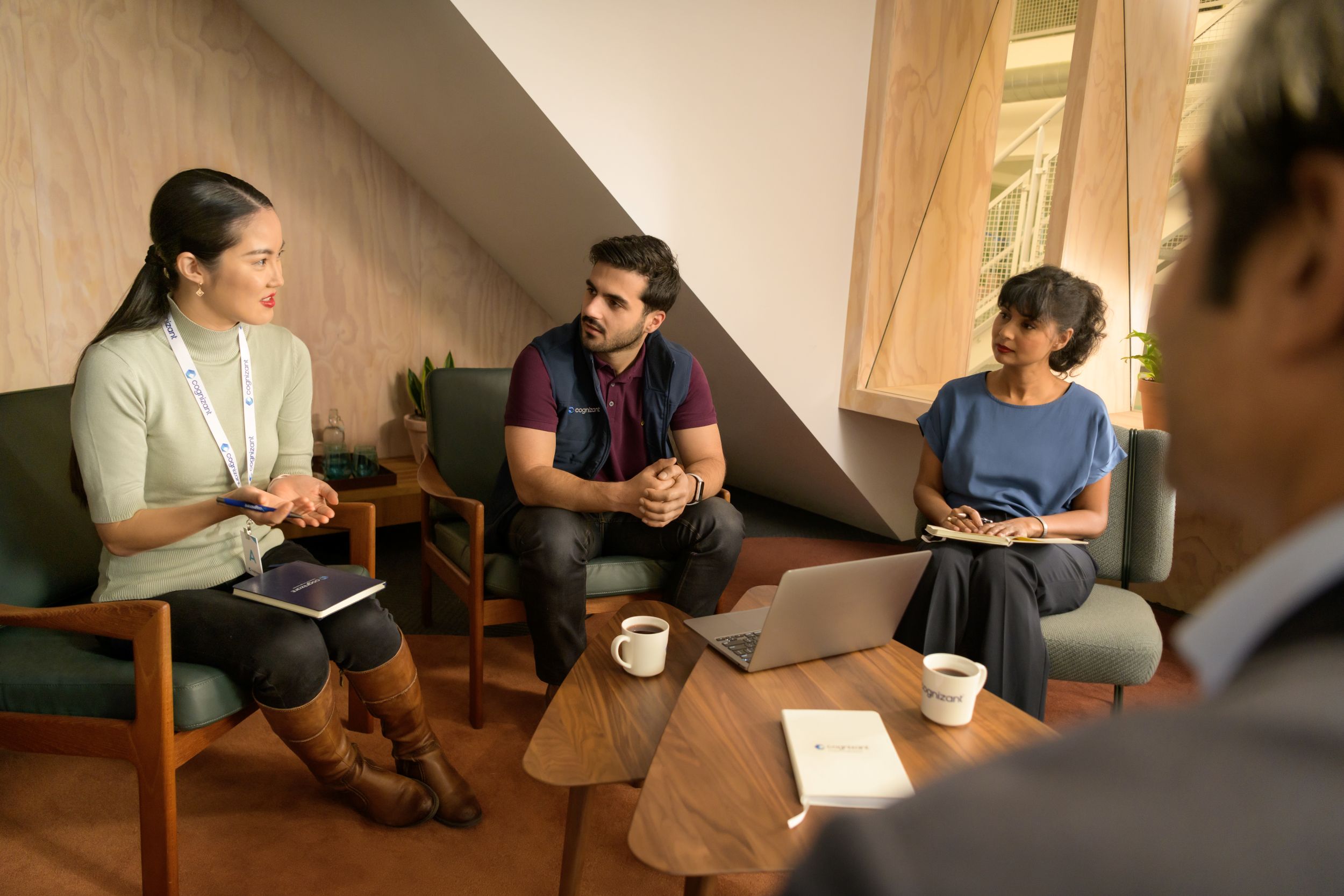 a group of people sitting in chairs and talking