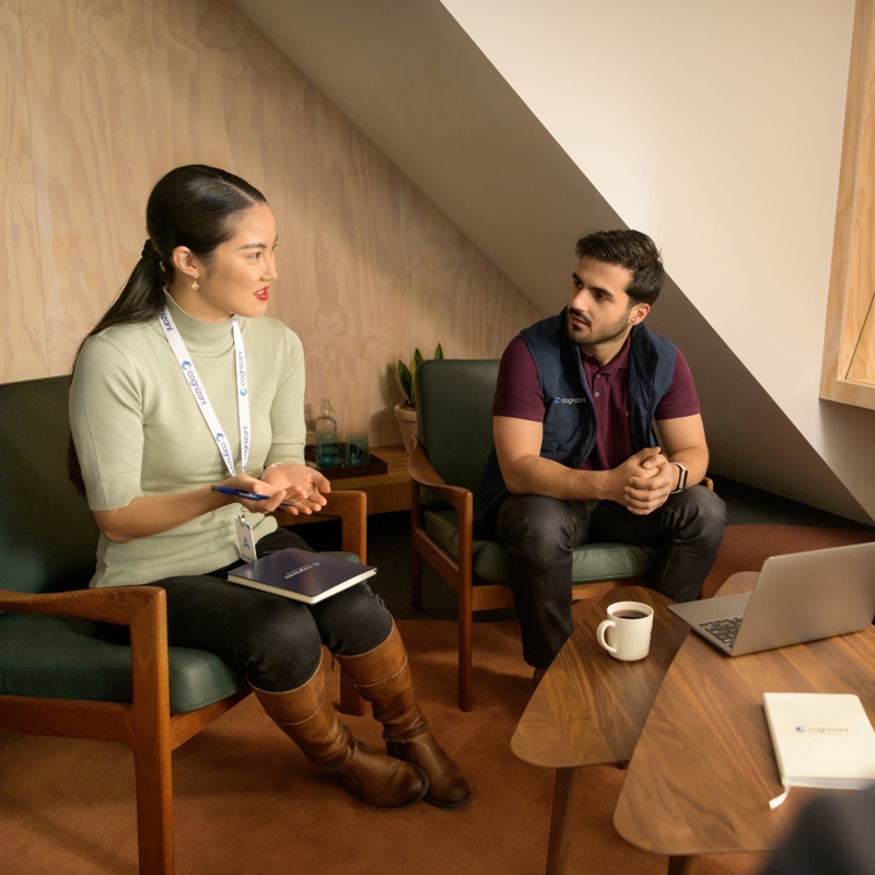 a group of people sitting in chairs and talking
