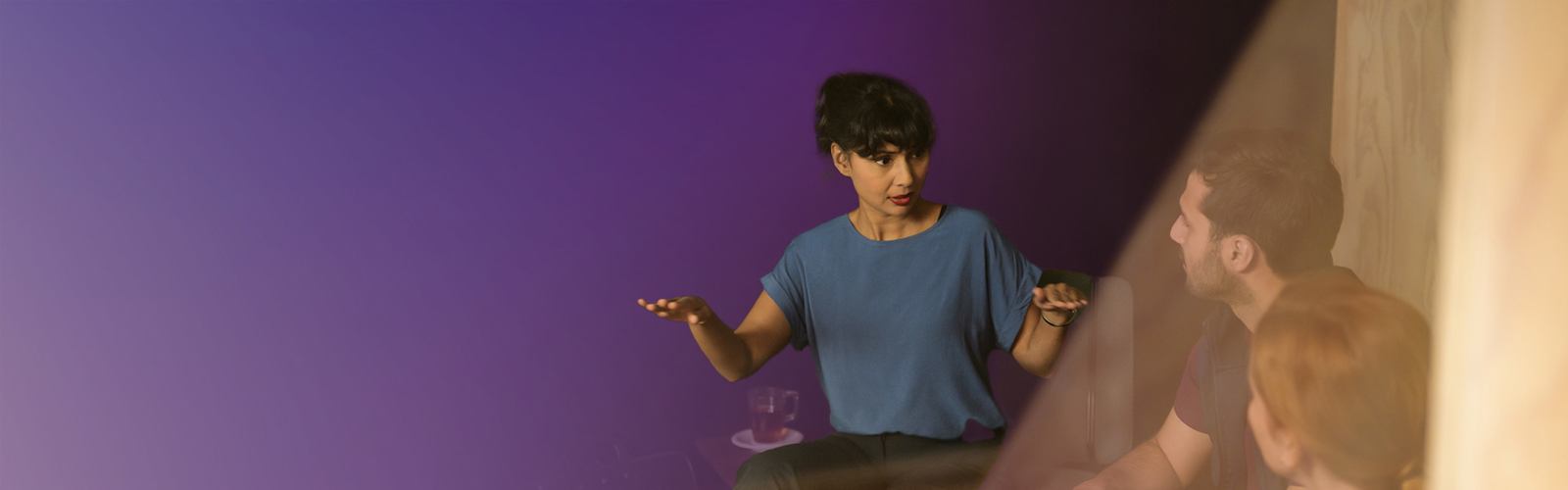 a person sitting in a chair with her hands out