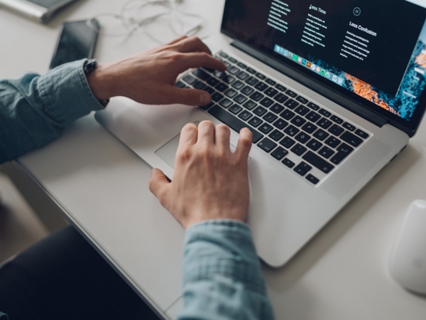 a person typing on a laptop