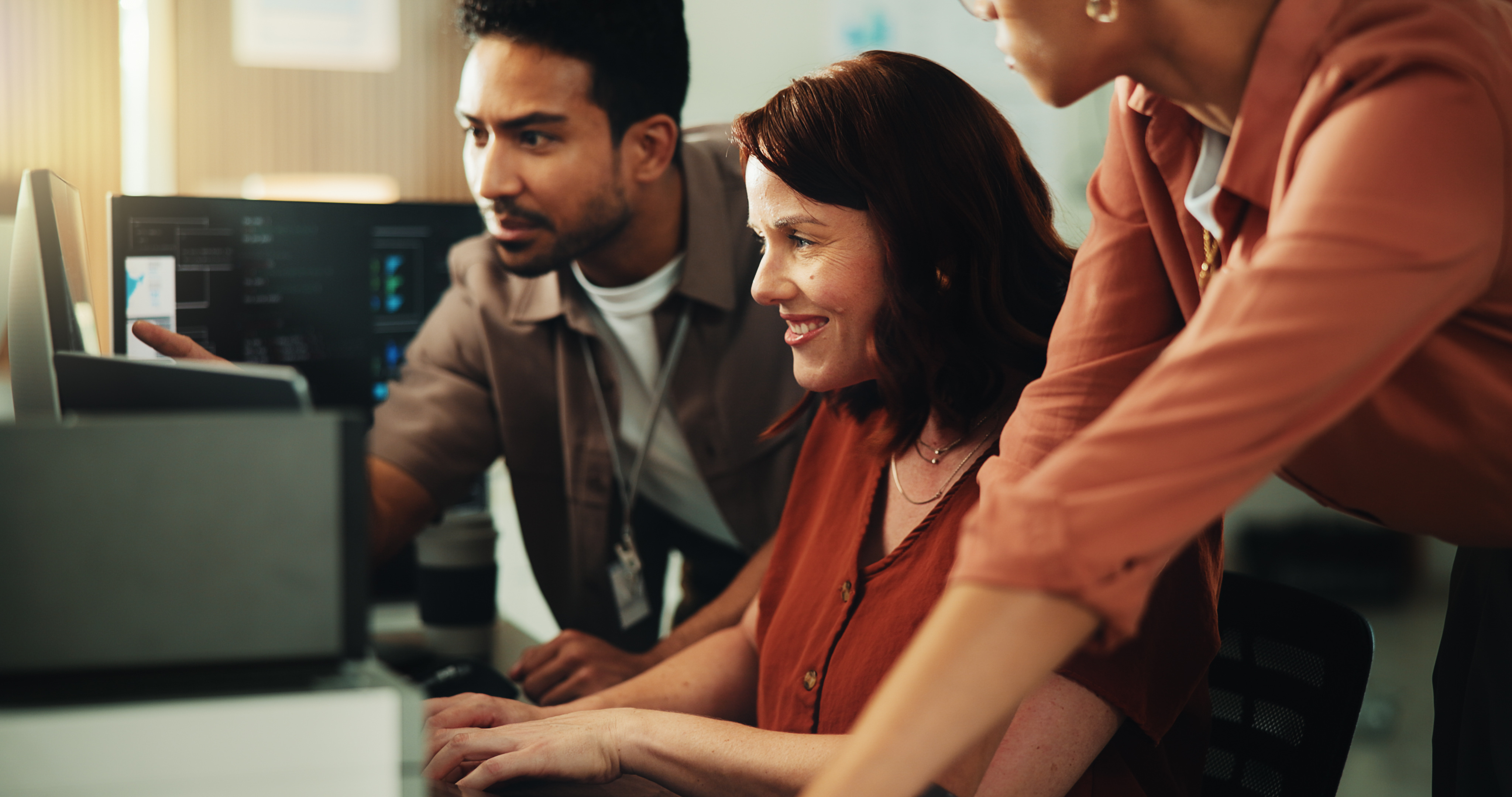 a group of people looking at a computer