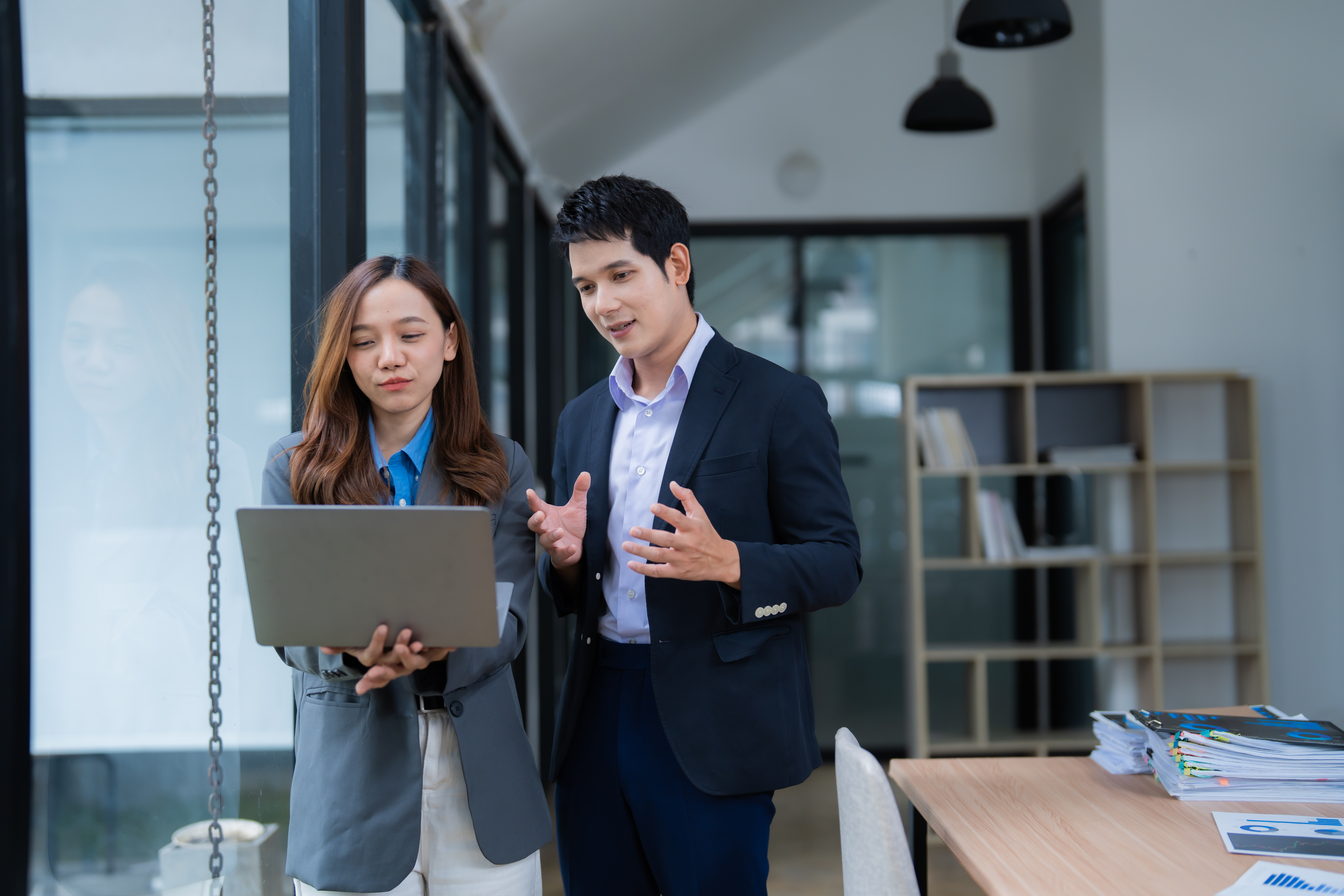 a person and person standing in an office
