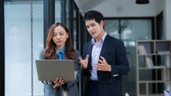 a person and person standing in an office