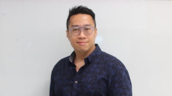 a person wearing glasses and a blue shirt