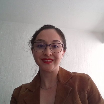 a person wearing glasses and a brown jacket