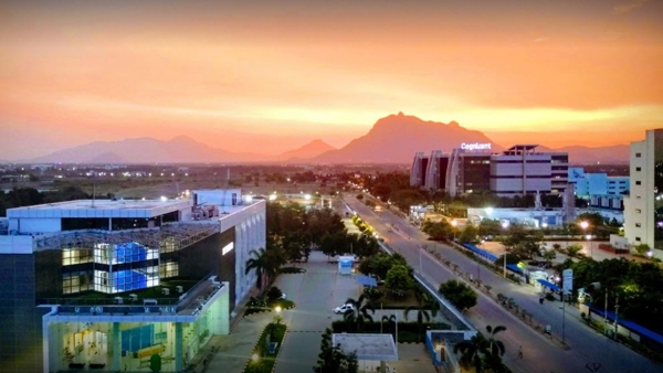 a city with buildings and mountains in the background