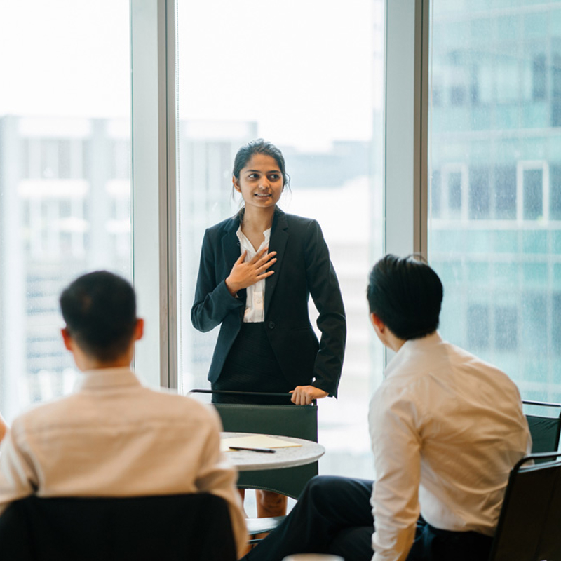 a person standing in front of a group of people