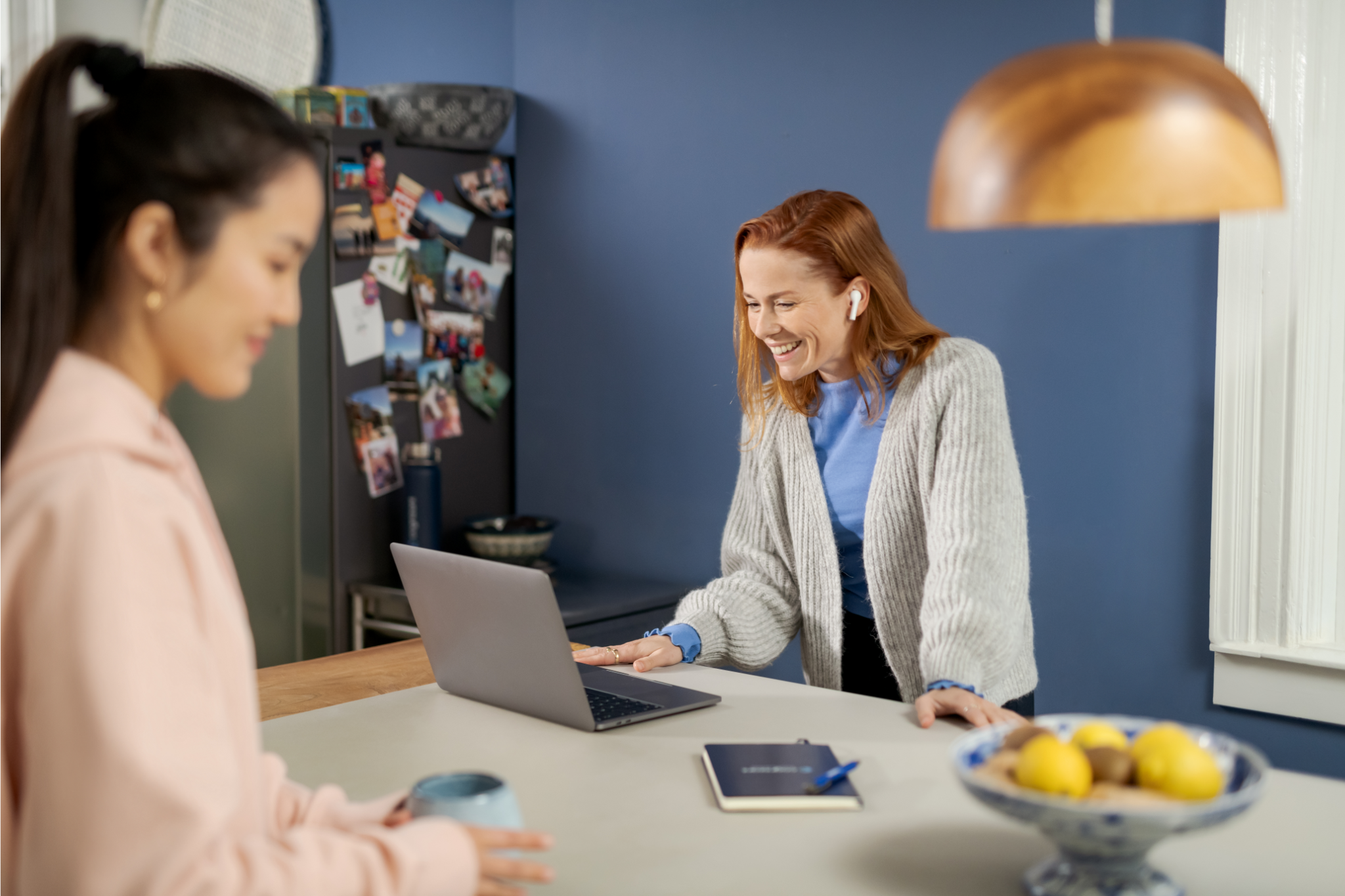 a person smiling at a laptop