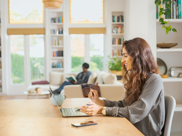 a person sitting at a table with a laptop
