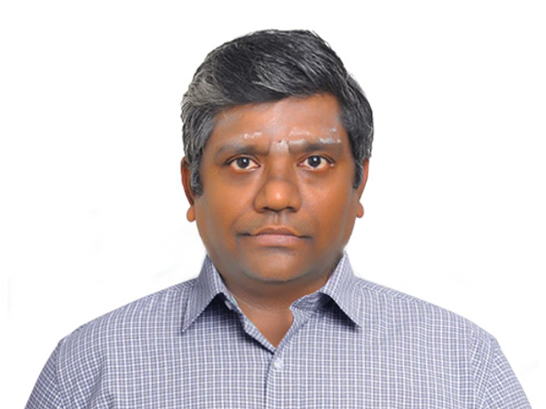 a person with grey hair and a blue checkered shirt