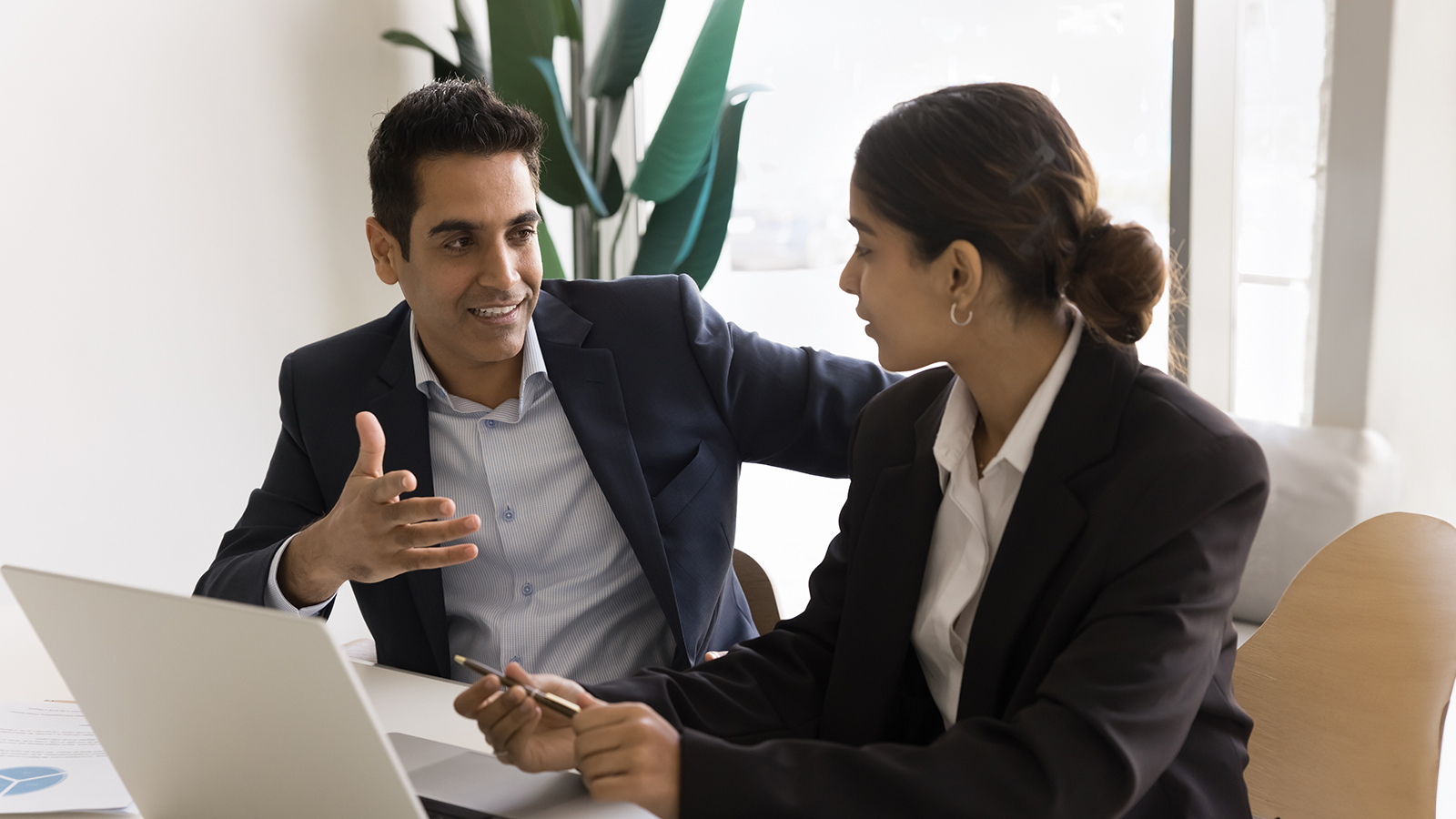 a person and person sitting at a desk