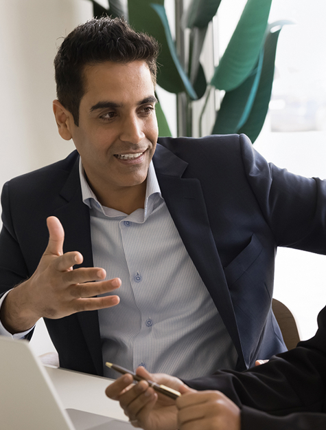 a person and person sitting at a desk